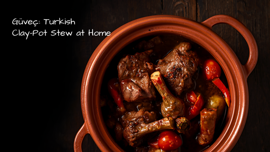 Turkish lamb güveç bubbling in an earthenware clay pot, layered with eggplant, peppers, and tomatoes