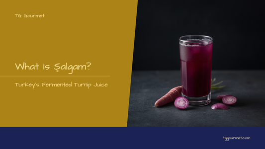 Glass of deep-red Turkish şalgam juice with a fermented black carrot stick, served beside Adana kebab