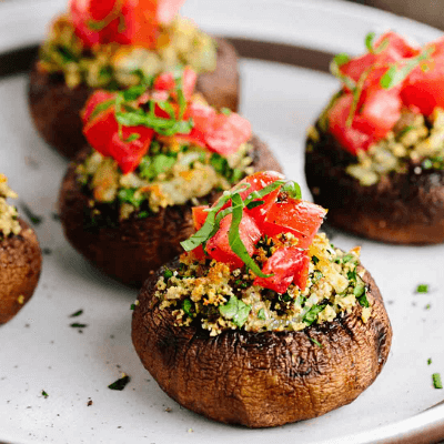 Tomato and mozzarella stuffed mushrooms baked with herbs and served warm