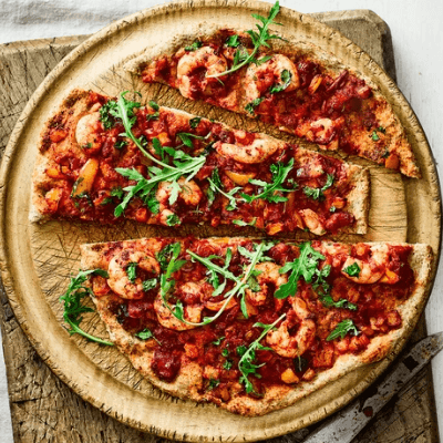 Prawn feta and semi-dried tomato pizza on a thin crust served warm